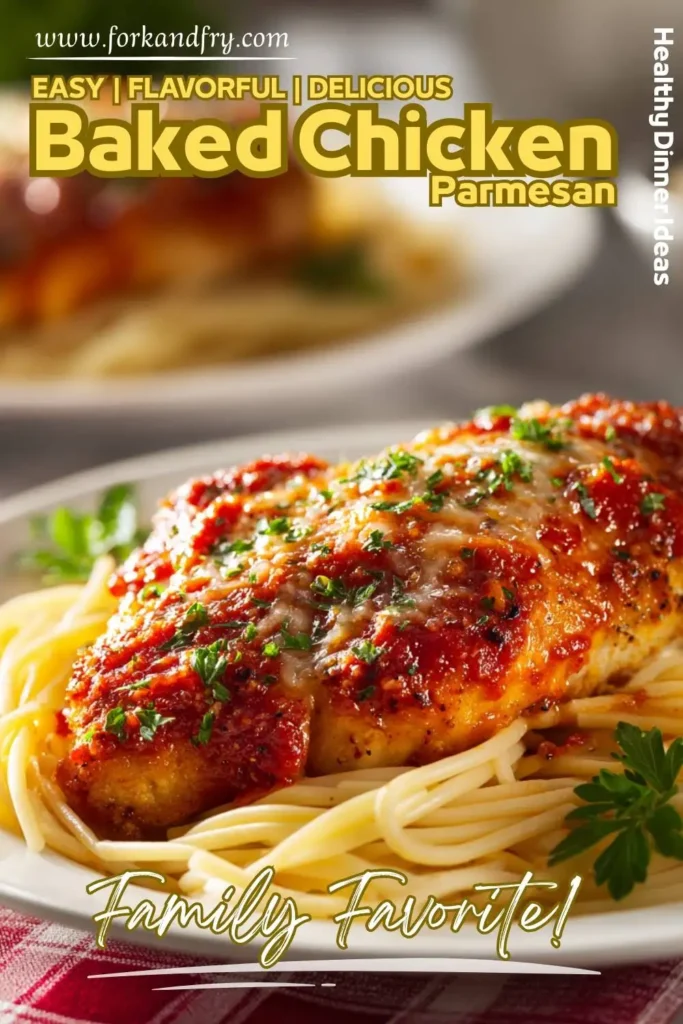 Oven-baked chicken parmesan served with green salad and lemon wedge on white plate
