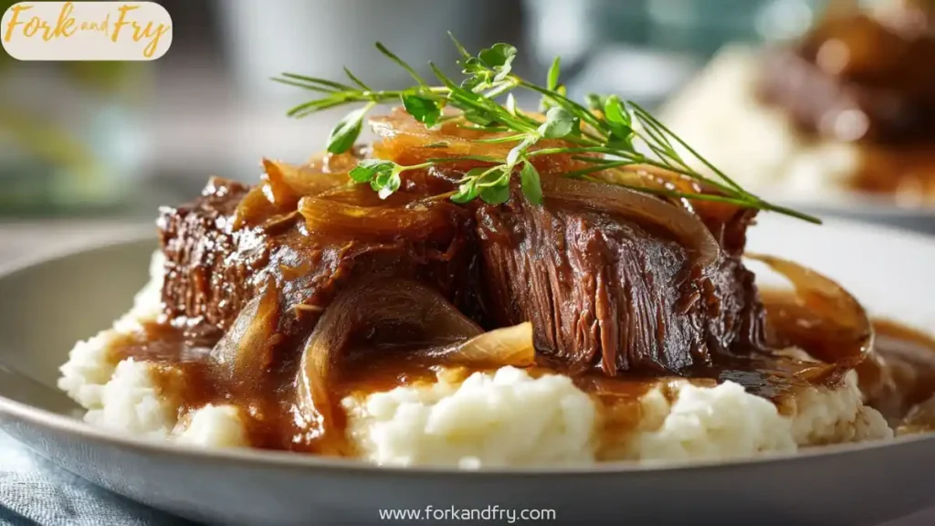 Tender beef roast in thick gravy served on mashed potatoes
