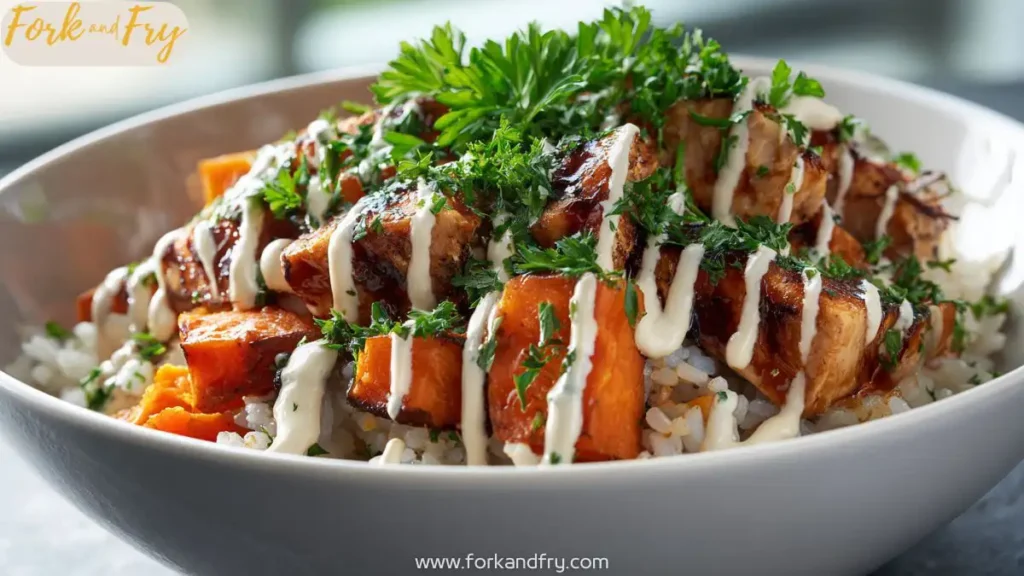 Close-up of healthy chicken and sweet potato bowl with brown rice and tahini sauce