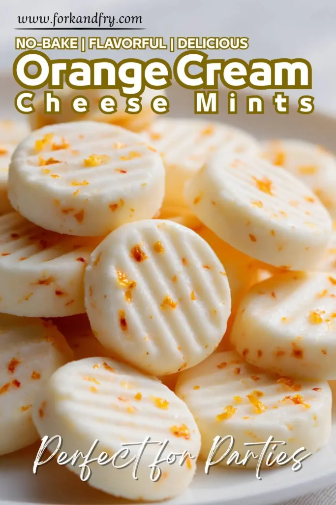 No-Bake Orange Cream Cheese Mints Close-up of orange butter mints on parchment paper