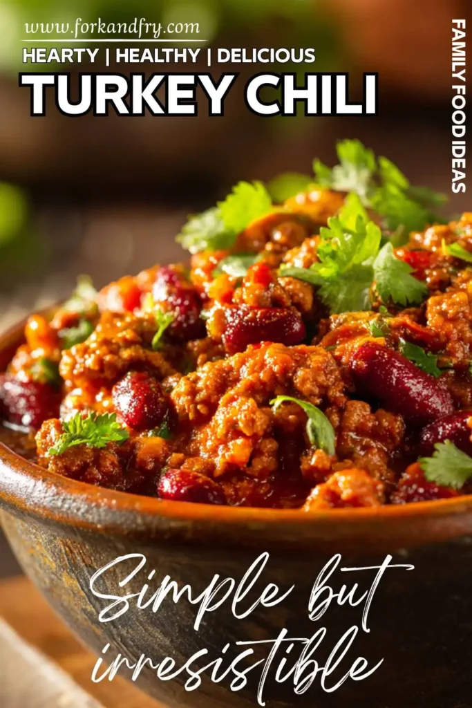 Healthy Crockpot Turkey Chili Healthy turkey chili with beans in slow cooker topped with cheddar