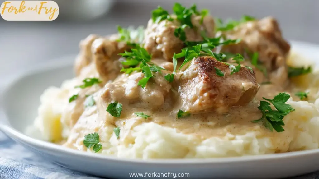 Creamy slow cooker chicken with rich sauce over mashed potatoes