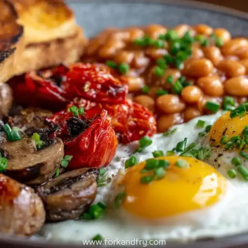 full english breakfast plate with eggs sausage toast beans mushrooms and tomatoes