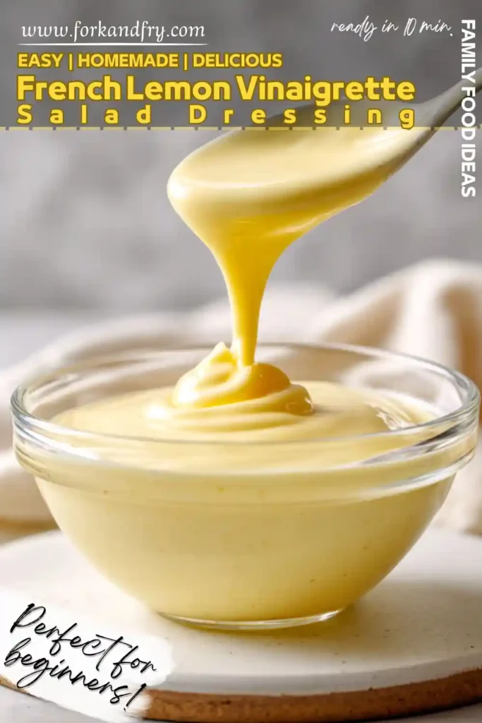 easy french lemon vinaigrette salad dressing recipe thick lemon vinaigrette pouring from spoon into glass bowl creamy and golden with smooth texture