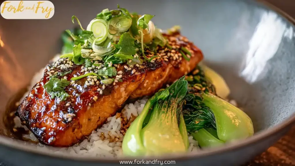 glazed miso salmon fillet on jasmine rice with baby bok choy scallions sesame seeds and cilantro garnish