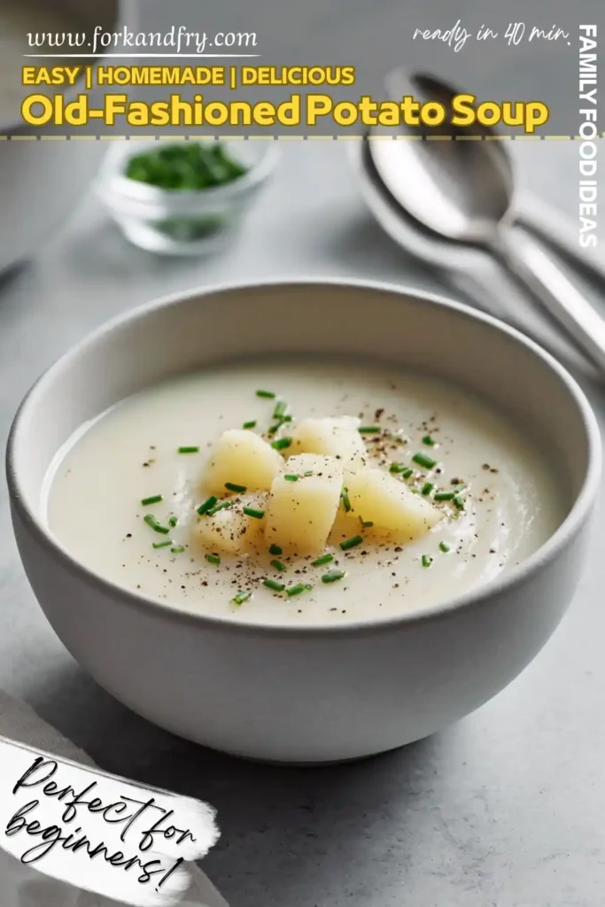 Old-Fashioned Potato Soup with Chives and Black Pepper Classic potato soup in a grey bowl topped with diced potatoes, chives, and black pepper