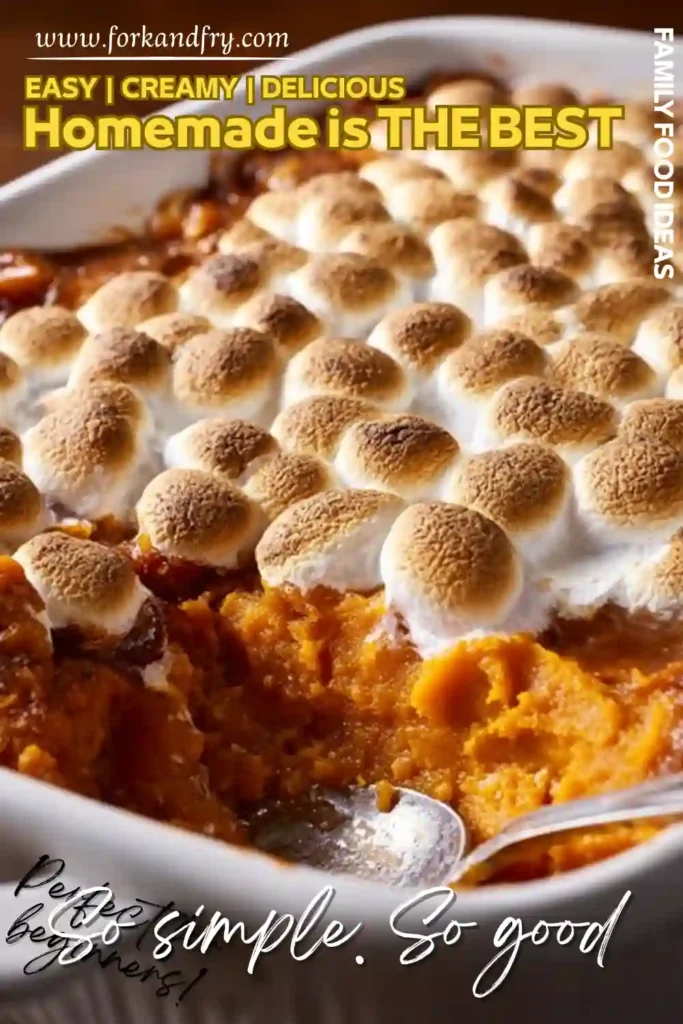 creamy sweet potato casserole with toasted marshmallow topping in a white dish and spoon