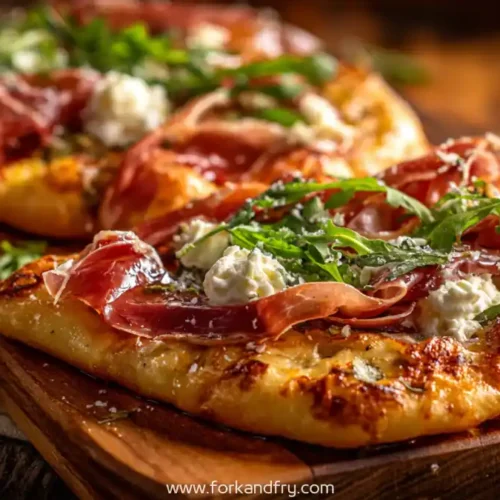 Crispy prosciutto and burrata flatbread pizza topped with arugula and honey drizzle