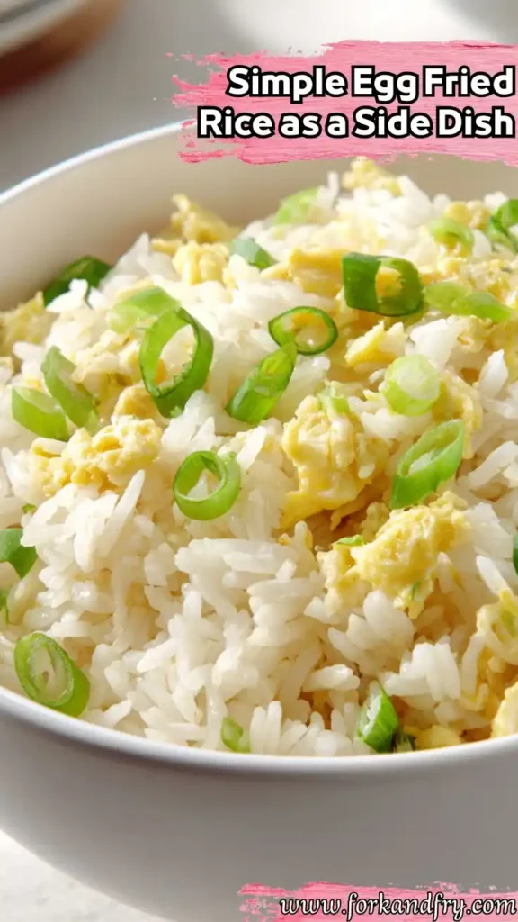 Close-up of simple egg fried rice with scallions in a white bowl