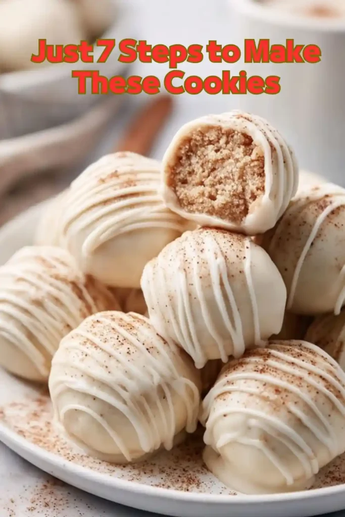 White chocolate truffles with cookie center on white plate sprinkled with cinnamon stacked and styled vertically