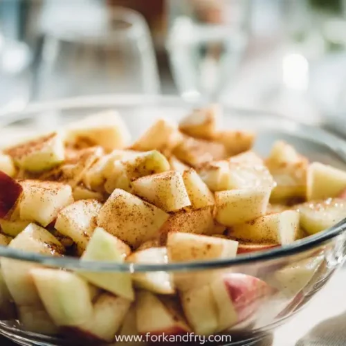 glass bowl of apple cinnamon fruit salad on elegant brunch table