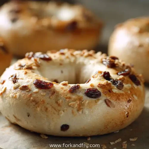 closeup of cinnamon raisin greek yogurt bagels with oats on baking tray
