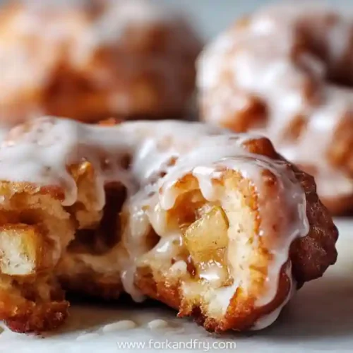 Glazed apple fritter donuts with gooey apple filling and vanilla icing