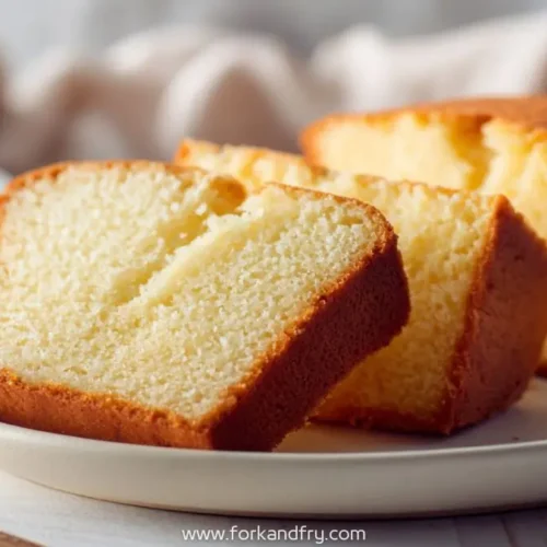 Slices of golden everyday pound cake with minimal sugar on a white plate