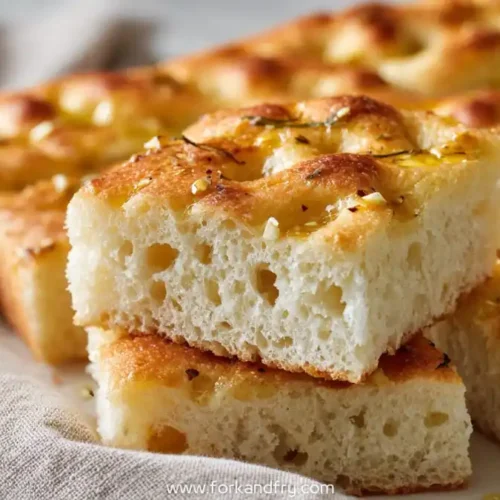 golden garlic focaccia slices with olive oil on sheet pan