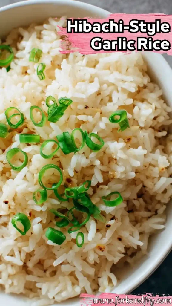Vertical Hibachi Garlic Rice with Crispy Bits and Scallions close-up of hibachi-style garlic rice with toasted grains and chopped green onions