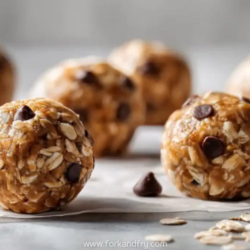 peanut butter oat energy bites with mini chocolate chips on parchment