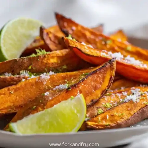 crispy air fryer sweet potato wedges with sea salt and lime wedges