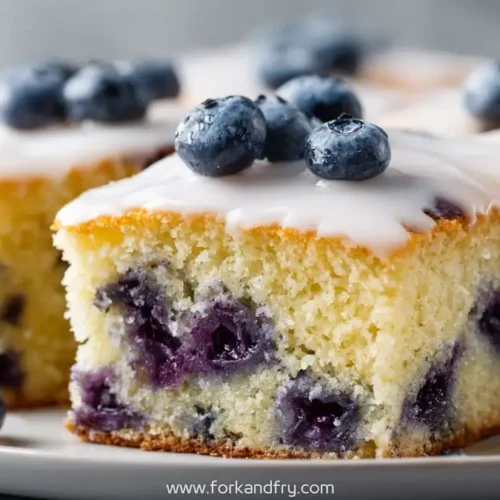 Blueberry sheet cake with light glaze and fresh blueberries on top