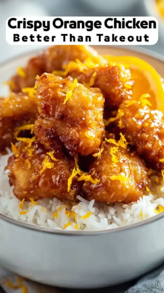 Crispy orange chicken coated in sticky citrus glaze served over white rice with fresh orange zest