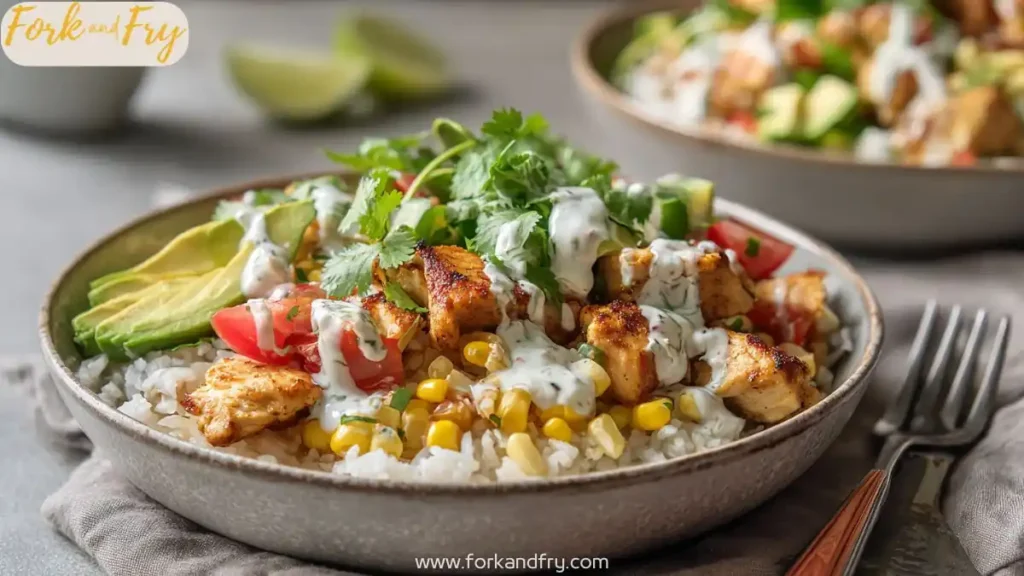 healthy chicken rice bowl with avocado corn tomatoes cilantro and creamy herb sauce