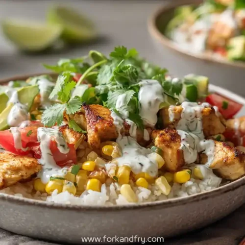 healthy chicken rice bowl with avocado corn tomatoes cilantro and creamy herb sauce