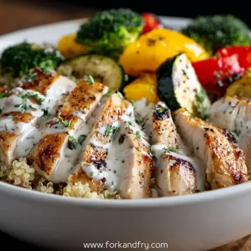 high protein grilled chicken quinoa bowl with roasted vegetables and creamy herb sauce