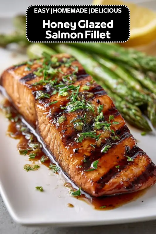 honey glazed salmon fillet with herbs and sauce served with asparagus