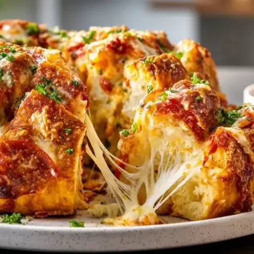 Cheesy pepperoni pull apart bread with melted mozzarella, pepperoni, and marinara dipping sauce.